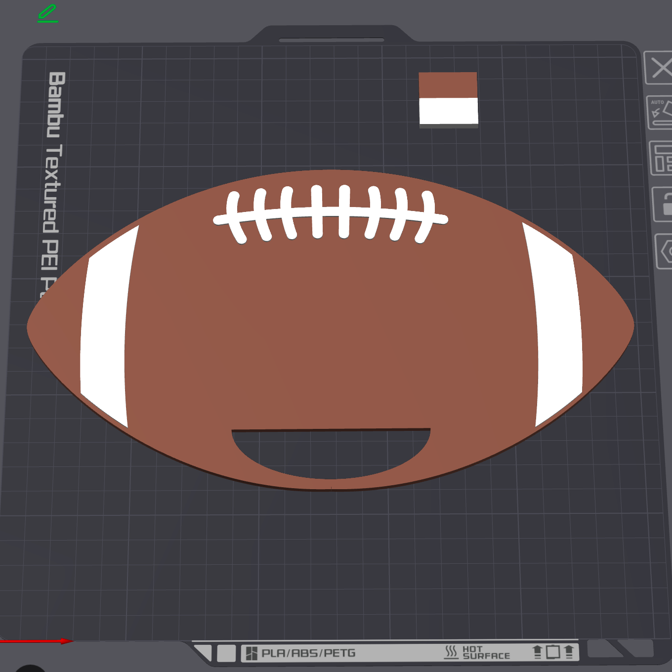 A 3D render of a football-shaped PETG print file preview on a dark gray grid workspace background, featuring a brown body with white laces and white side stripes.