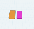 A 3D digital render showing two rectangular boxes on a light blue grid background. The box on the left is orange with a small recessed slot on its front face, and the box on the right is solid magenta/purple.