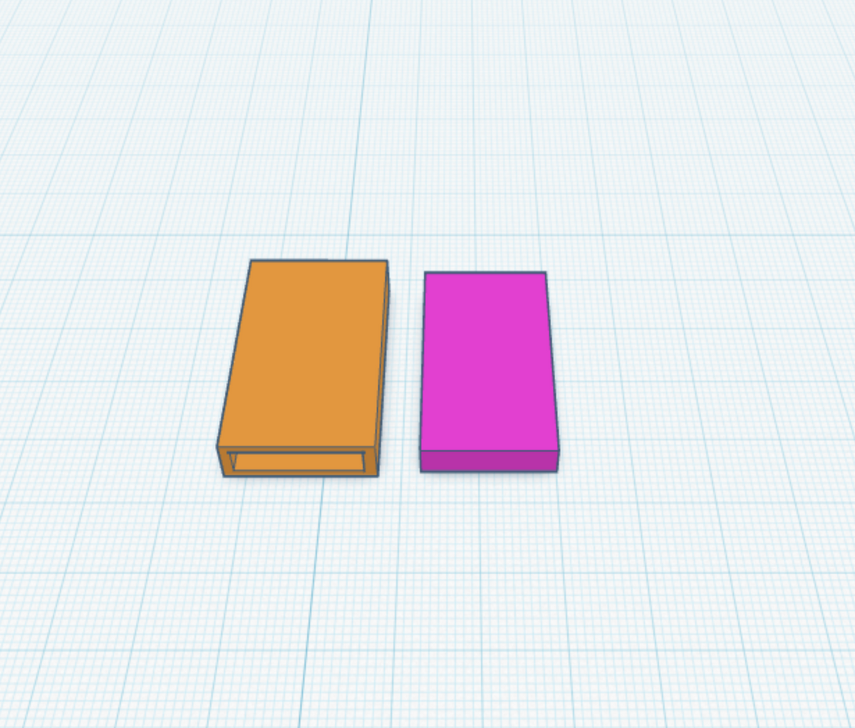A 3D digital render showing two rectangular boxes on a light blue grid background. The box on the left is orange with a small recessed slot on its front face, and the box on the right is solid magenta/purple.